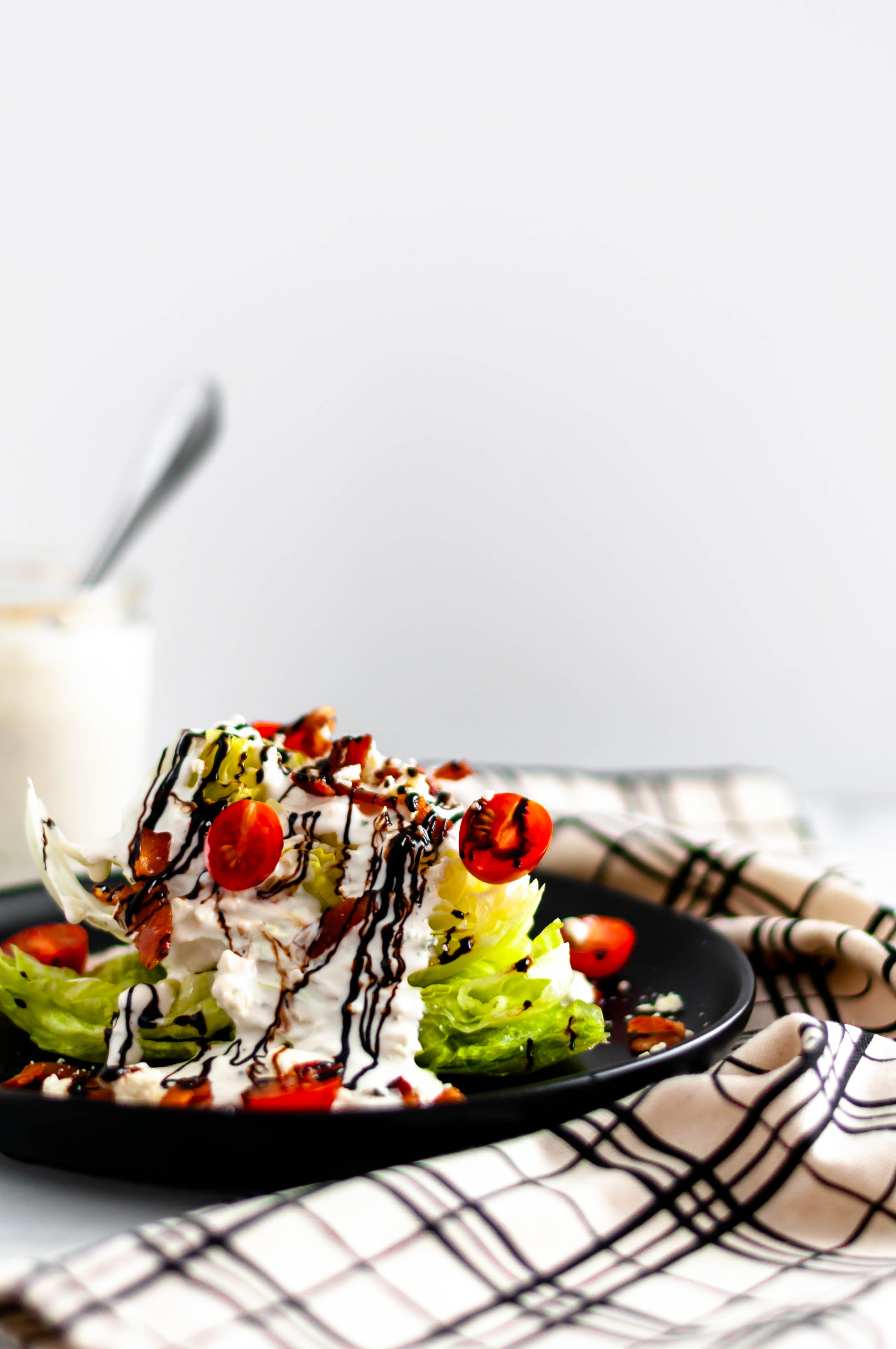 Start off any meal with this Classic Wedge Salad. Homemade blue cheese and a drizzle of balsamic glaze provide so much flavor to this classic salad.