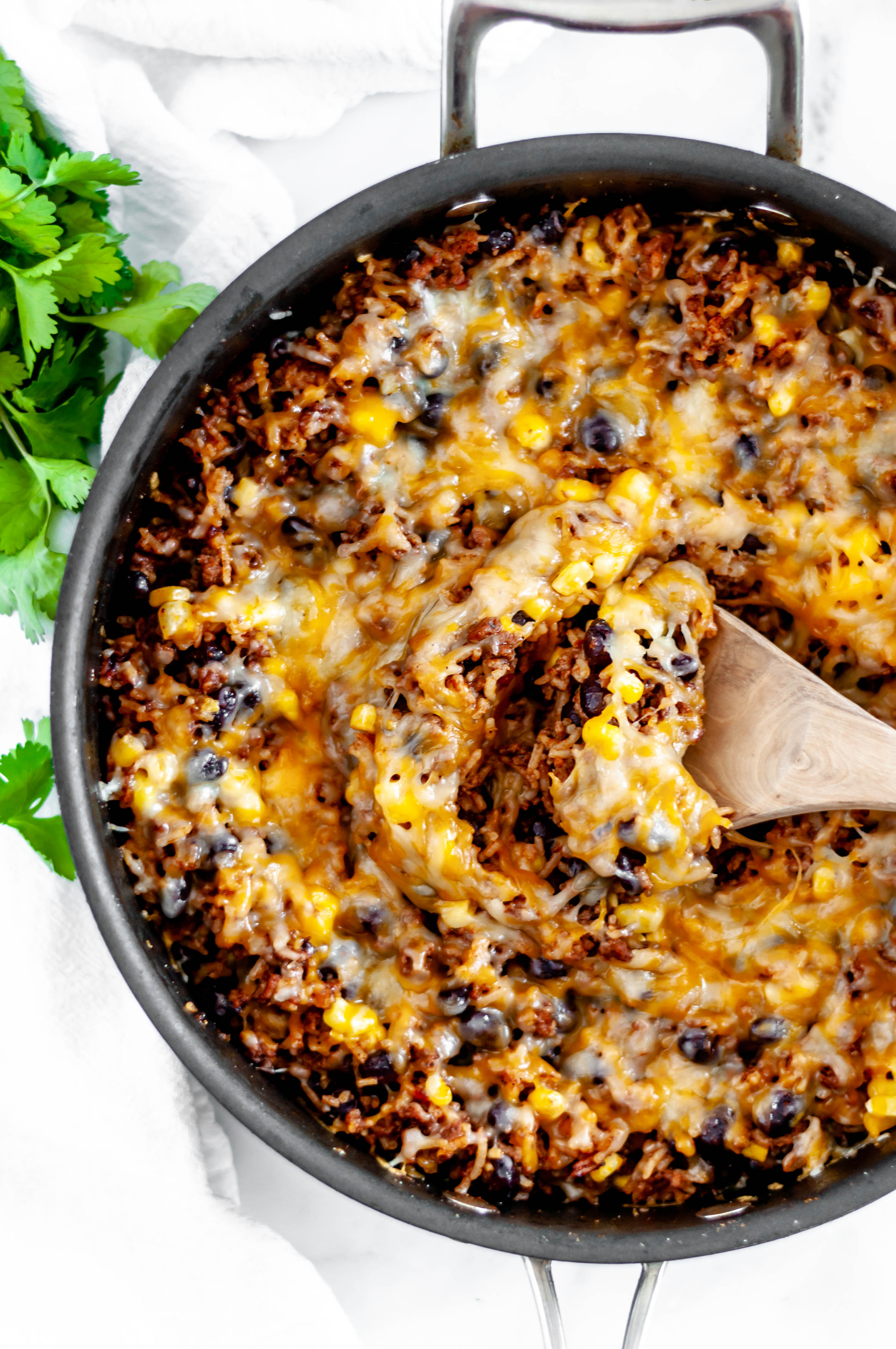 This Cheesy Mexican Skillet is done in 30 minutes for the perfect weeknight meal. Packed full of Mexican flavor from enchilada sauce, cumin, chili powder and more.