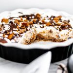 Chocolate Chip Cookie Dough Ice Cream Pie is the ultimate dessert. Cookie dough crust, cookie dough ice cream, whipped cream and chocolate syrup.