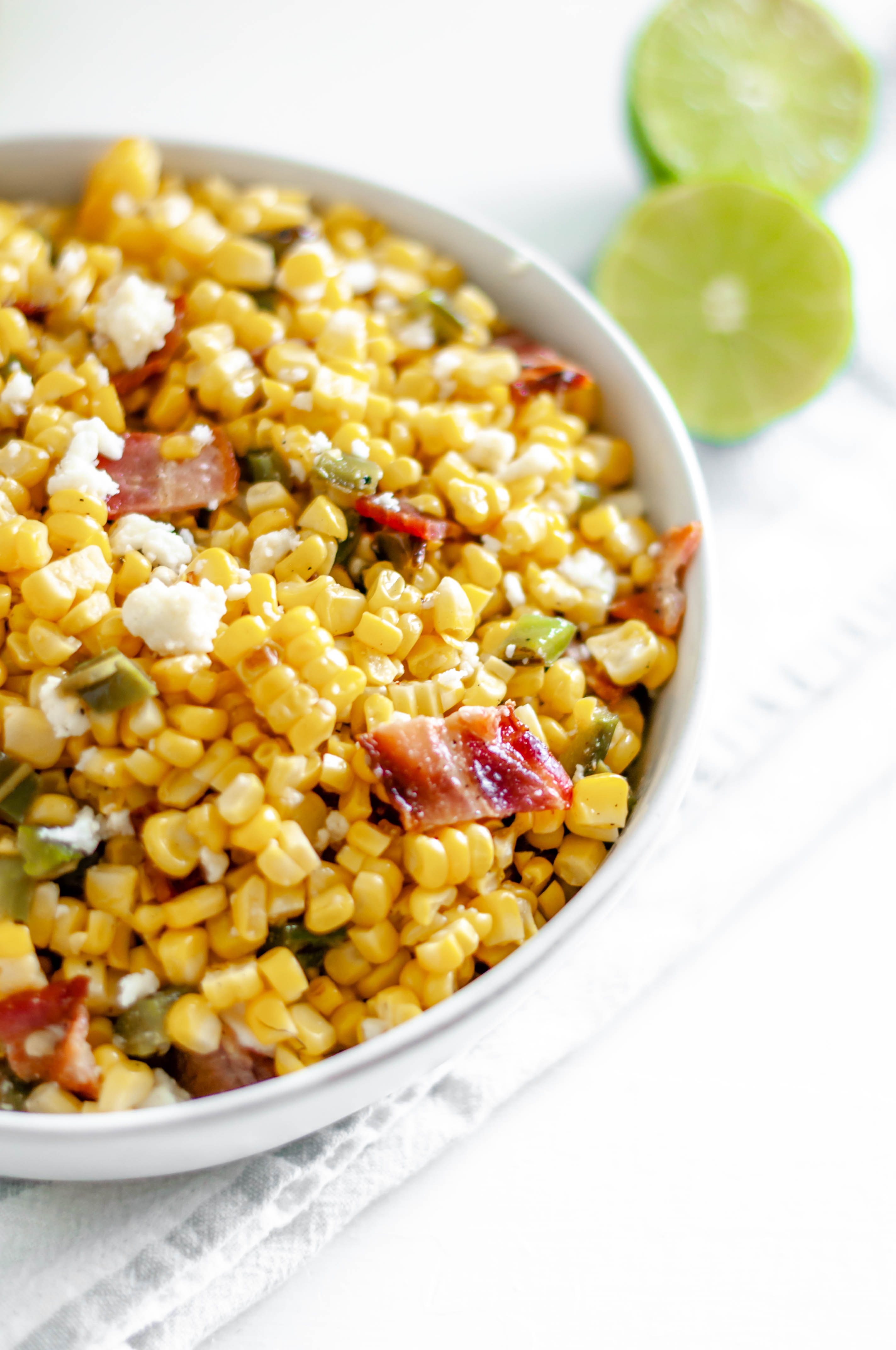 This Grilled Corn Salad with Bacon and Jalapeno is your next potluck dish. Sweet grilled corn, smoky bacon, spicy jalapeno and a bright lime dressing. The perfect addition to any summer barbecue or potluck.