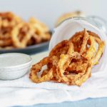 These Crispy Onion Rings with Buttermilk Dill Dressing will be the hit of the party. Perfect for appetizers, game day or to go with your burgers.