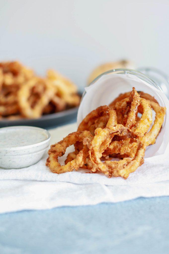 These Crispy Onion Rings with Buttermilk Dill Dressing will be the hit of the party. Perfect for appetizers, game day or to go with your burgers.
