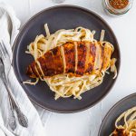 This Blackened Chicken Alfredo is the ultimate weeknight meal. Done in 30 minutes and packed with flavor. Easy enough for any weeknight but fancy enough for guests too. Homemade blackening seasoning covered tender chicken cutlets served over simple, cheesy homemade fettucine alfredo.