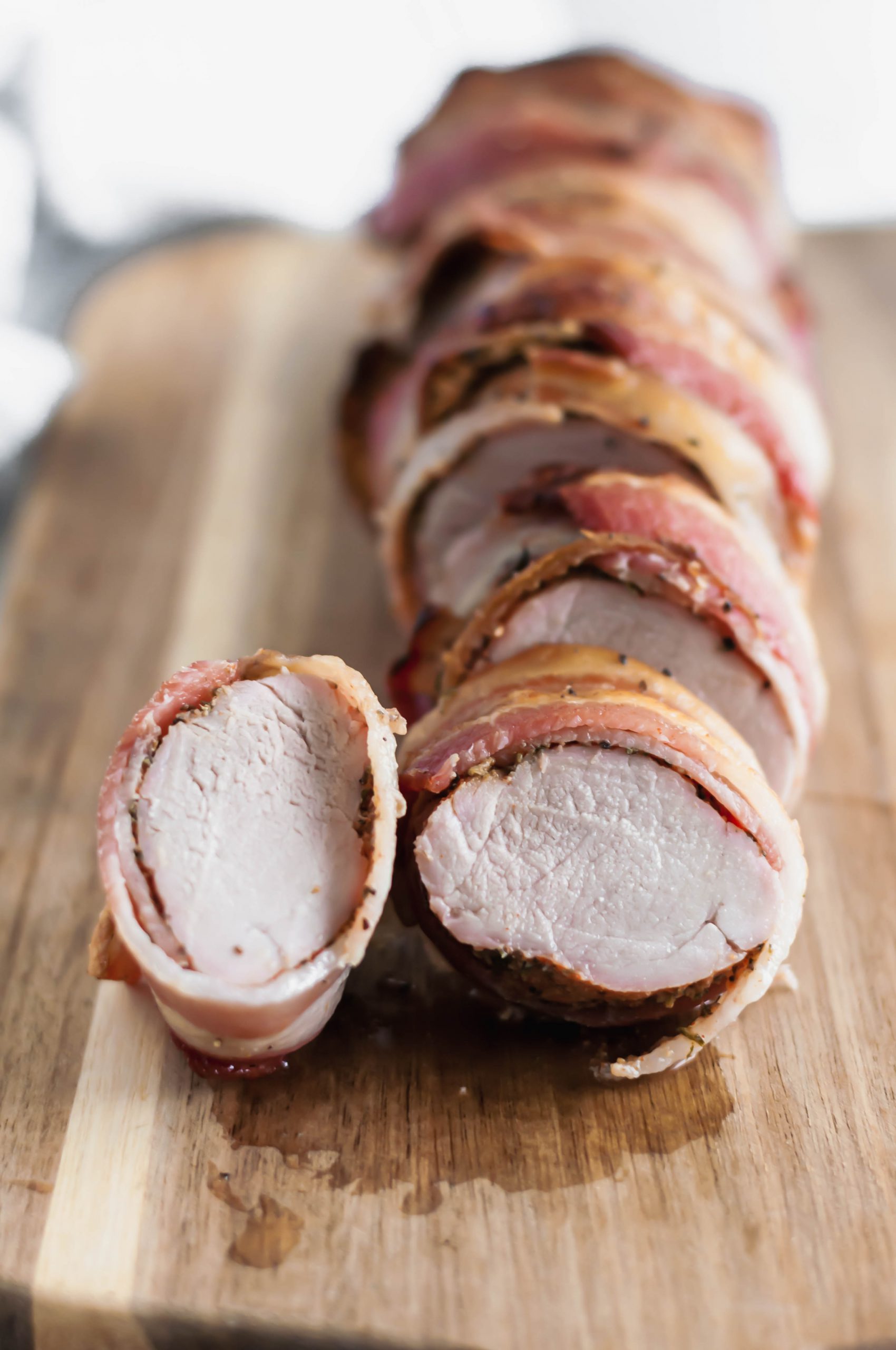 This Bacon Wrapped Pork Loin is fancy enough for guests but easy enough for weeknight meals. Packed with herbs and all the crispy bacon.