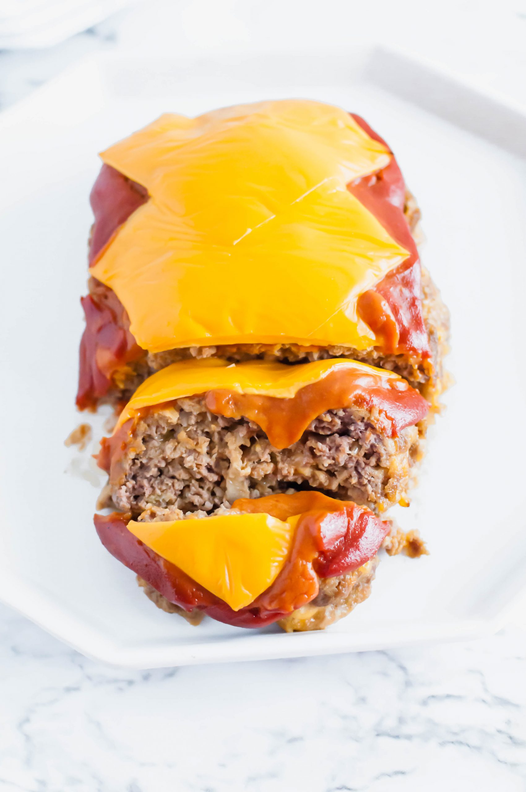 All the glorious flavors of a cheeseburger packed into an easy, weeknight friendly Cheeseburger Meatloaf. It's sure to become a family favorite.