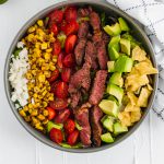 This Southwest Steak Salad is the ultimate summer salad. Packed with grilled steak, charred corn, avocado, crumbled queso fresco, tomatoes and crushed tortilla chips.