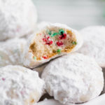 Tender, melt in your mouth Christmas Snowball Cookies are the perfect addition to your baking list this season. Super festive and fun.