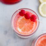 The drink of summer has arrived. Pink Lemonade Vodka Punch is so fruity and refreshing. Make a big batch for your next party. It's officially time for all the refreshing, fruity, summery drinks. This Pink Lemonade Vodka Punch is SO simple to make and fulfills all those requirements. Pureed strawberries and raspberries provide so much fruity flavor while the lemonade brings some delicious zippiness. Get ready for the perfect summer drink.