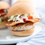 chicken bacon ranch slider on a white plate with two in the background