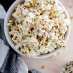 Straight down shot of everything bagel popcorn in a ceramic bowl.