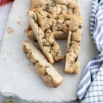 Mini focaccia on a marble board cut with a few slices arranged around.