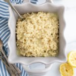 Square dish filled witth lemon couscous drizzled with lemon herb vinaigrette.