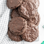 A pile of chocolate mint cookies on a wire rack.
