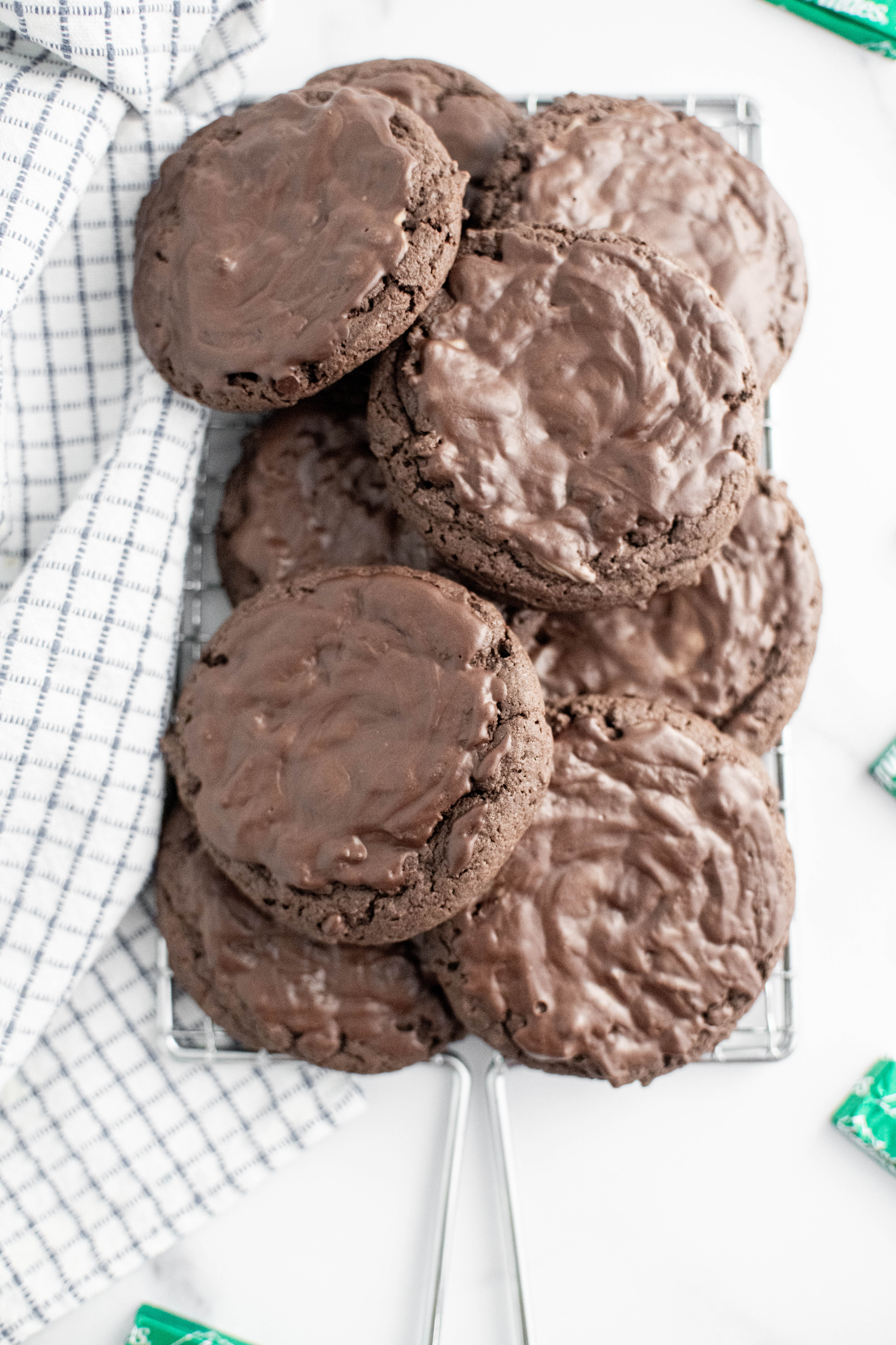A pile of chocolate mint cookies on a wire rack.